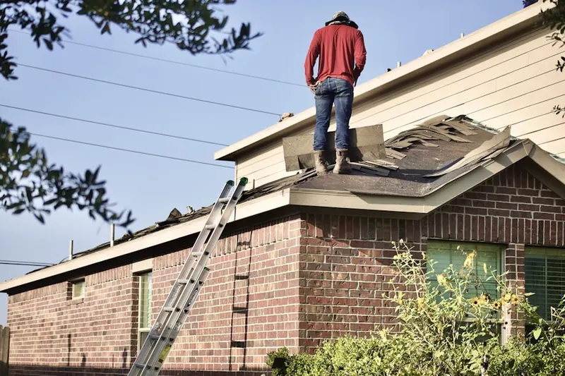 Professional roofer working on a residential roof in Solon